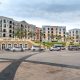 Fasad modern Apartemen Mediterania Garden Residence 2 dengan taman hijau dan balkon menghadap kota